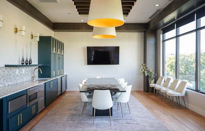 A modern kitchen with a dining table and chairs.