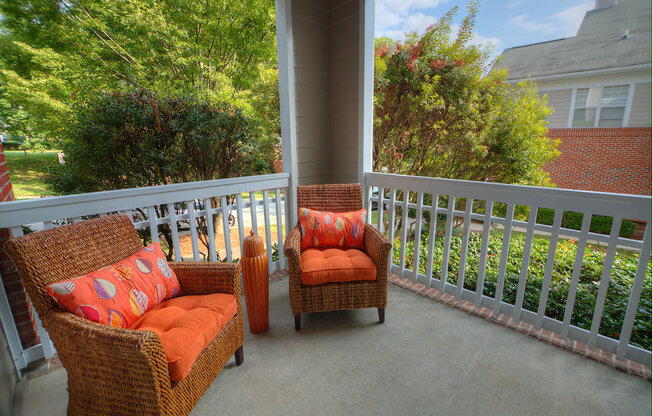 A patio with two chairs and a table.