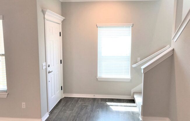 B3 (1-car) Entry with laminate wood flooring facing staircase