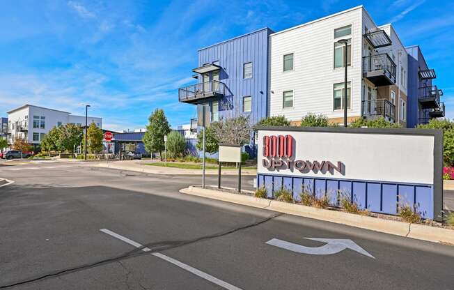 A street view of a building with a sign that reads "Uptown".