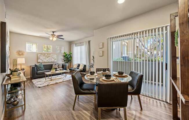 A modern living room with a dining table set for four.