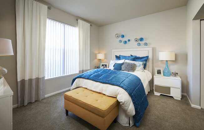 a bedroom with a large bed and blue and white bedding