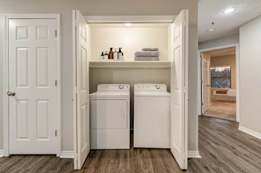 A small laundry room with a washer and dryer in it.