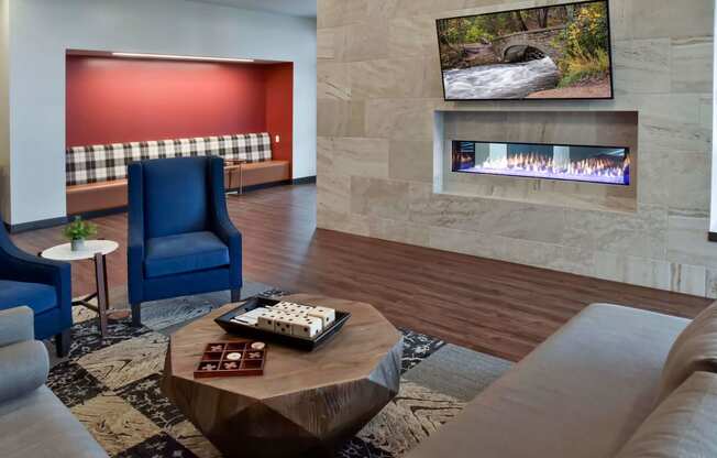 Clubroom fireplace lounge with cozy seating nooks.