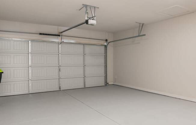 a white garage with white doors and a light on the ceiling