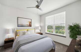 a bedroom with a large bed and a ceiling fan