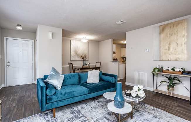 a living room with a blue couch and a table