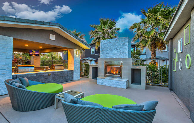 A patio with a fireplace and seating area.