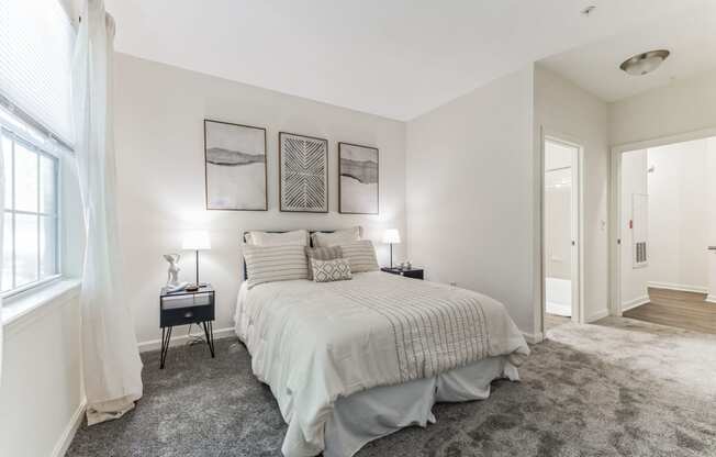 a bedroom with a large bed and a window