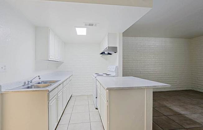 A kitchen with white cabinets and a white counter top.