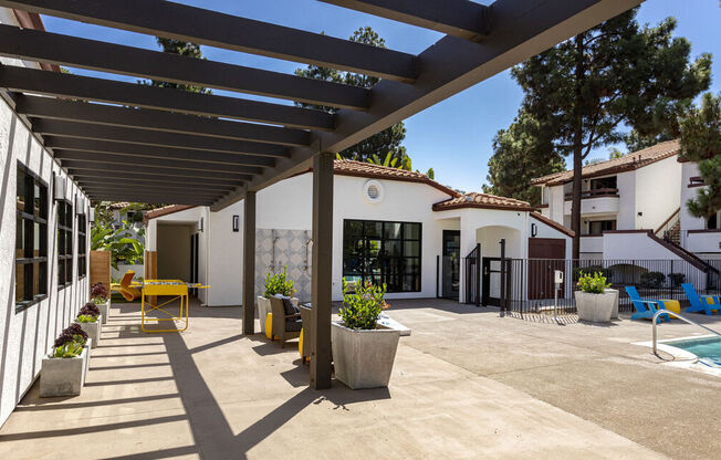 a patio with a white building and a swimming pool at La Jolla Blue, California