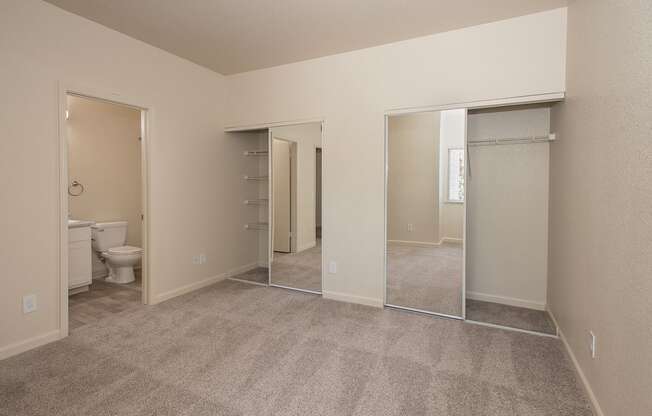 A room with a carpeted floor and mirrored closet doors at Sunset Summit, Rocklin, CA, 95765