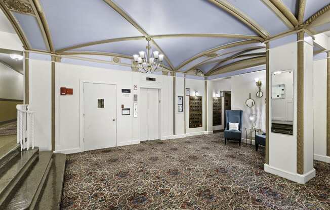 a large lobby with a vaulted blue ceiling and chandeliers at Stockbridge Apartment Homes, WA 98101