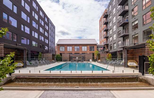 a swimming pool in between two tall buildings at The Audubon New Haven, Connecticut, 06511