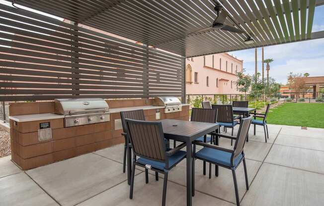 A patio with a table and chairs under a pergola.