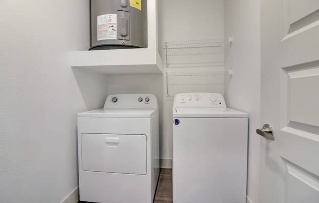 a small laundry room with a washer and dryer in it and a door
