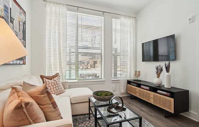 a living room with a couch and a table and a television