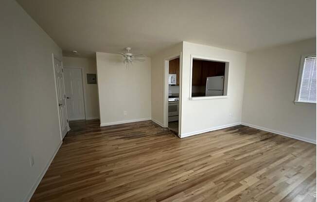 A room with wooden flooring and a window.