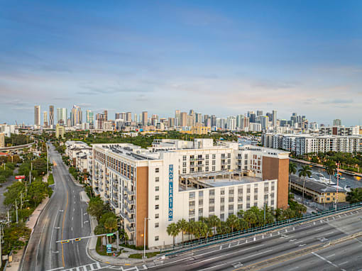 an aerial view of a building with a city in the background