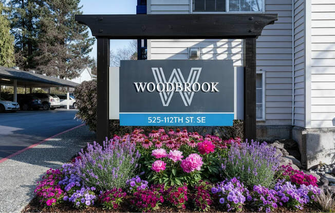 A sign for Woodbrook is displayed in front of a building.