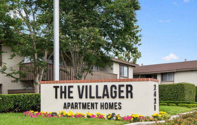 a view of the village apartments sign