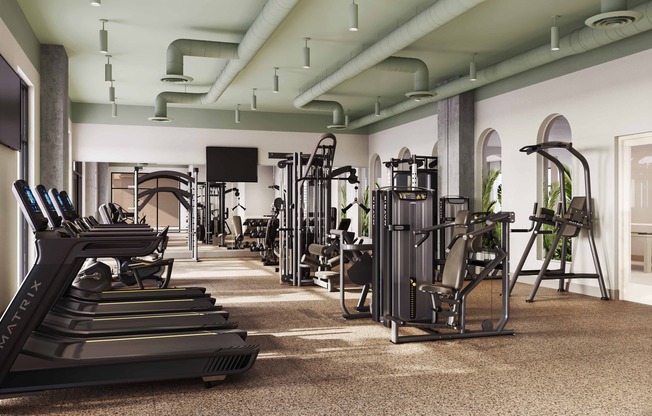 Club-quality fitness studio with TRX station, Peloton bikes, and private training studio.