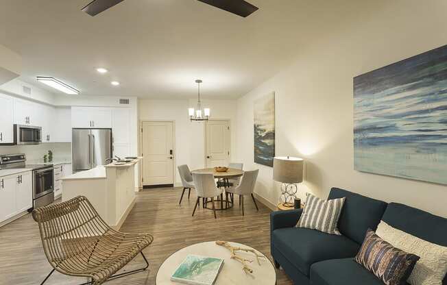 a living room and kitchen with a table and chairs and a couch