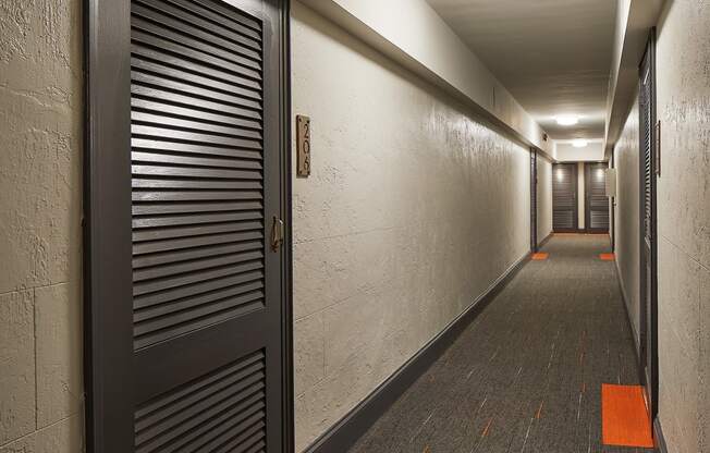 a hallway with a black door in a building