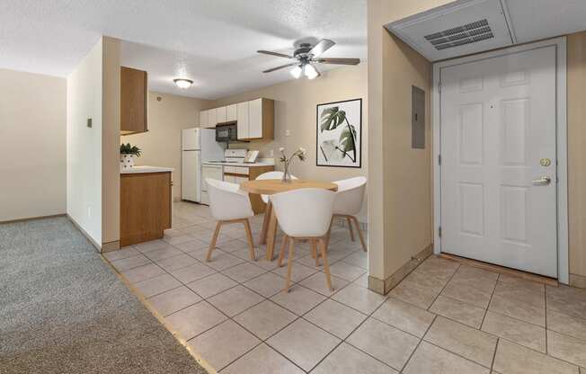 a dining room with a table and chairs and a kitchen