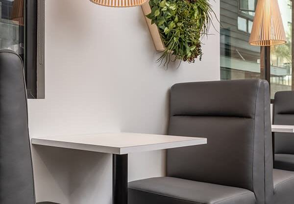 a couple of black chairs and a white table in a room