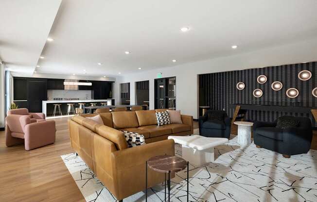 A modern living room with a large sectional sofa and a patterned rug.