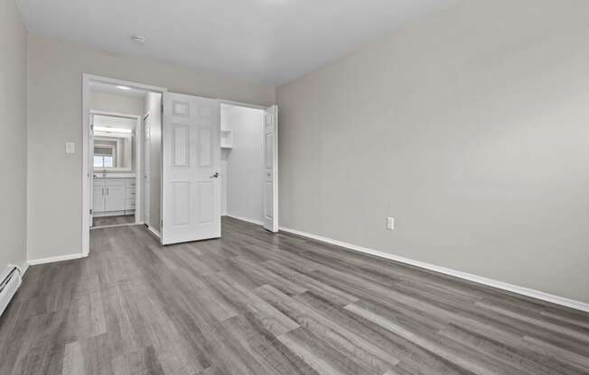 the living room of a new home with white walls and wood flooring