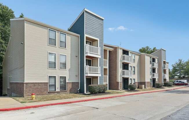 a street view of an apartment building with a fire hydrant