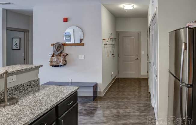 Kitchen with granite counter tops and a stainless steel refrigerator at Heritage at Oakley Square, Ohio, 45209