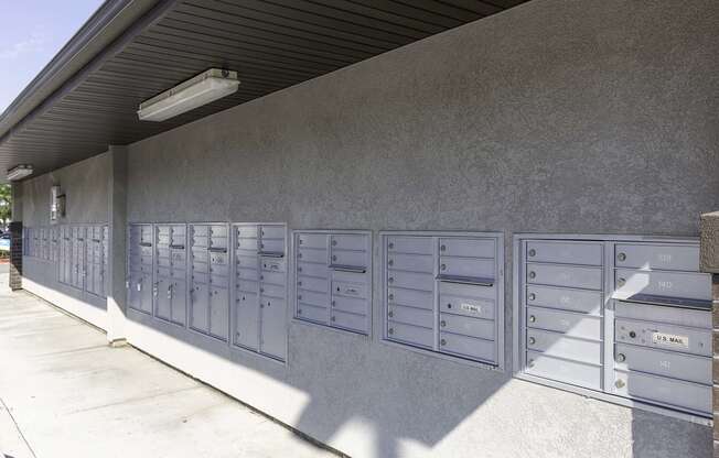 a picture of the side of a building with a bunch of mailboxes