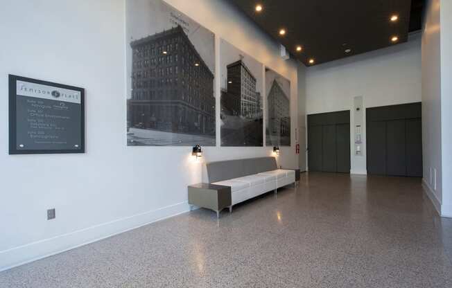 Lobby with elevators, seating, and historic photos at Jemison Flats, Birmingham, 35203