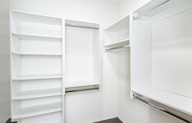 A spacious closet with built-in shelving and plenty of room to organize.