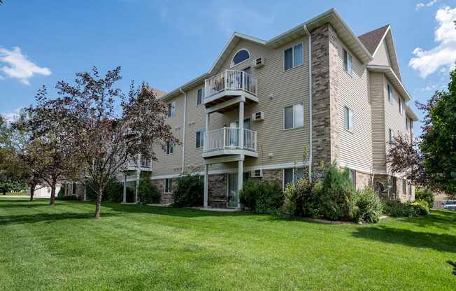 A large apartment building with a balcony on the second floor.