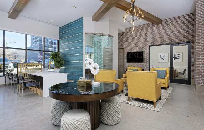 Lobby area with circular table, large sofa chairs and boardroom style table