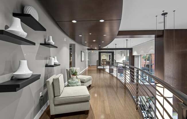 a large living room with a spiral staircase and white furniture