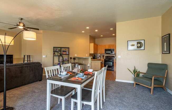A dining room with a table set for four.