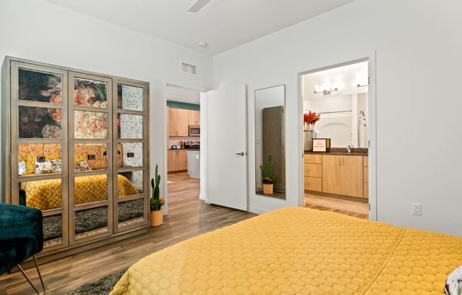 a bedroom with a yellow bed and a glass closet