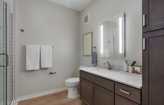 a bathroom with gray walls and a wooden floor