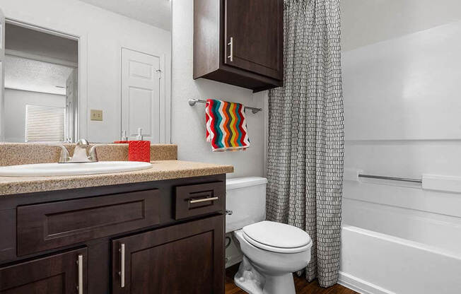 a bathroom with a white toilet and a shower