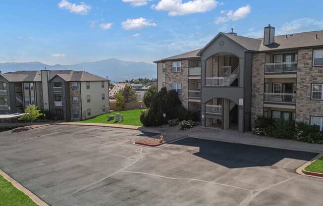 an empty parking lot in front of an apartment building