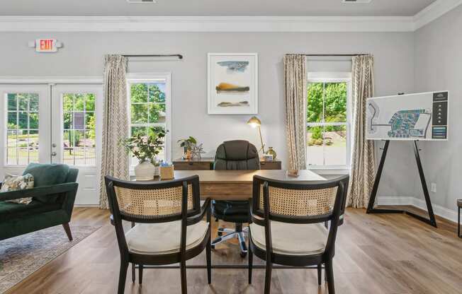 a dining room with a table and chairs and a easel in a room with