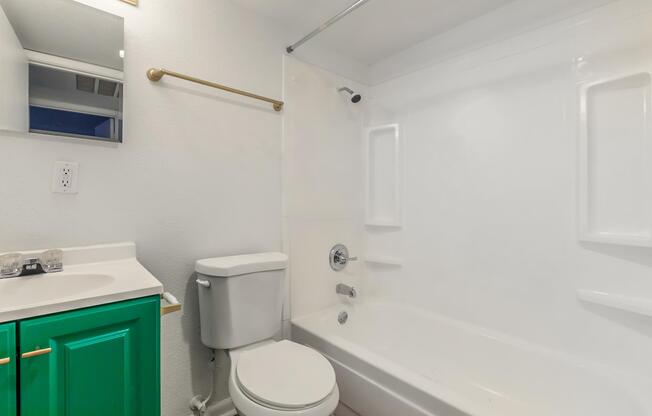 a white sink sitting under a mirror