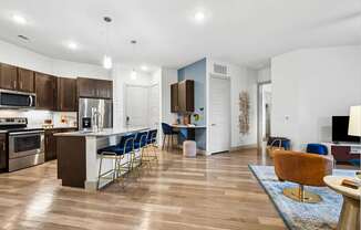 A modern kitchen with a dining area and a living room.