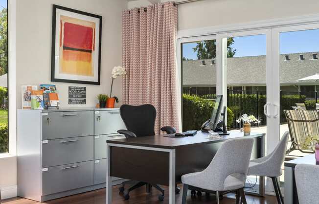 a home office with sliding glass doors to a patio