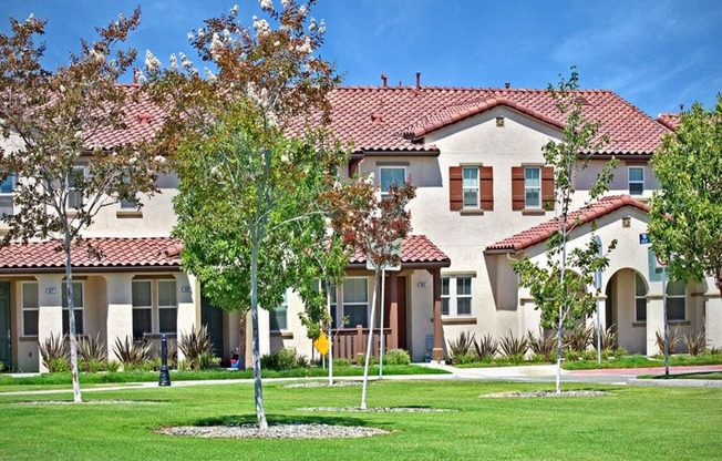 a large house with trees in front of it at The Vines at Riverpark, LLC, Oxnard, CA 93036